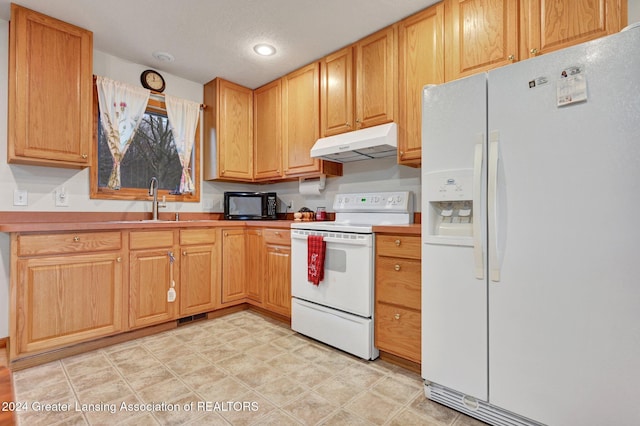 kitchen featuring a textured ceiling, sink, and white appliances