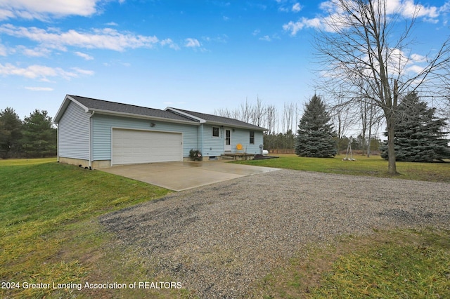 ranch-style house with a garage and a front lawn