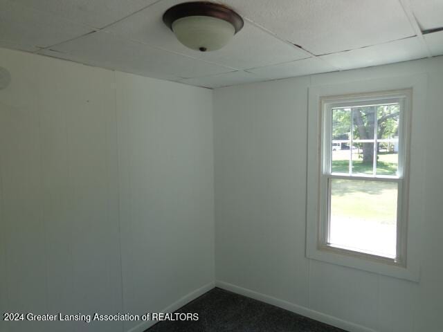 empty room with a paneled ceiling