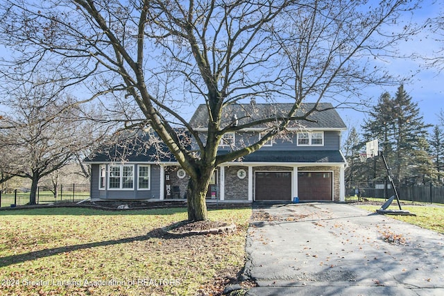 view of front property featuring a garage and a front lawn