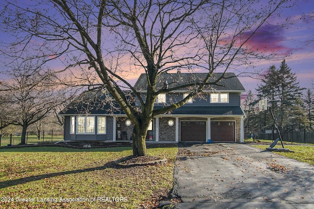 view of front of home featuring a garage and a lawn