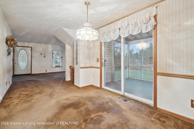 unfurnished dining area with carpet floors, vaulted ceiling, and an inviting chandelier