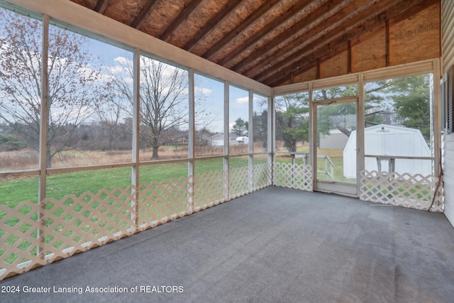 unfurnished sunroom with a wealth of natural light and lofted ceiling