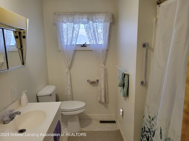 bathroom featuring tile patterned floors, vanity, and toilet