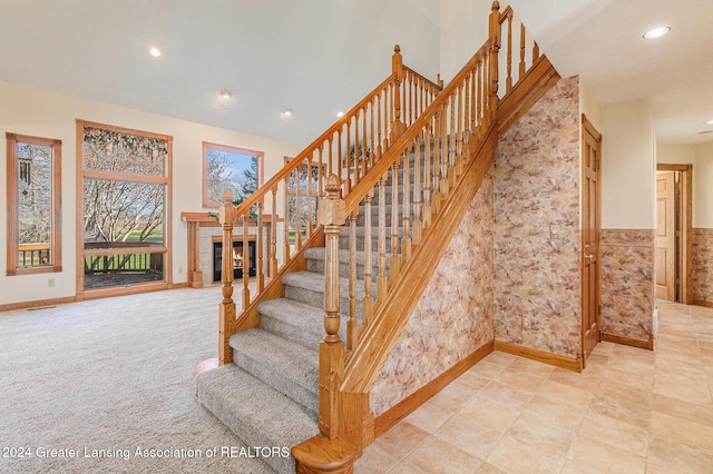 stairway featuring carpet