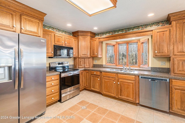 kitchen with light tile patterned flooring, sink, and appliances with stainless steel finishes