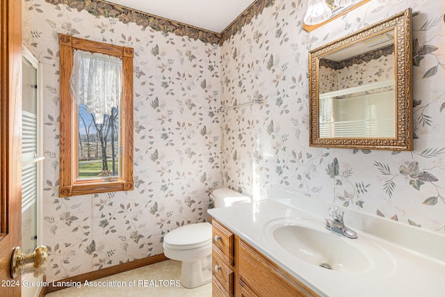 bathroom with tile patterned flooring, vanity, and toilet