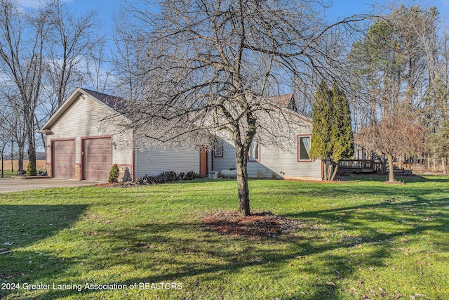 view of property exterior with a garage and a lawn