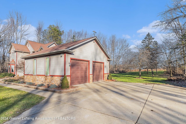 view of home's exterior with a lawn and a garage