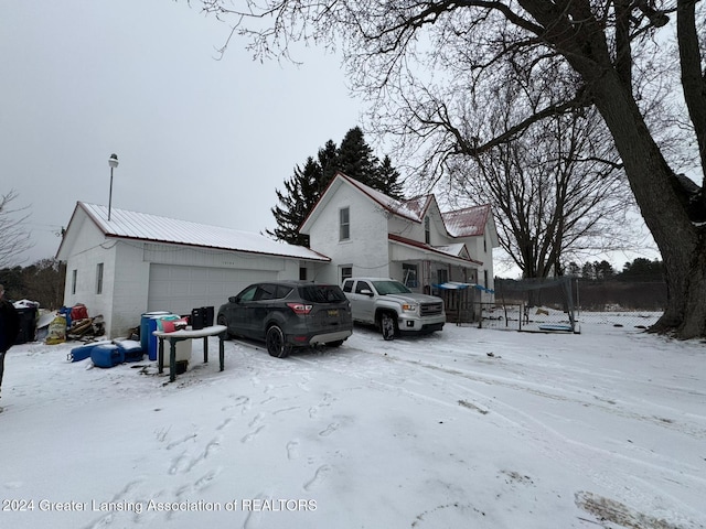 view of front of property featuring a trampoline and a garage