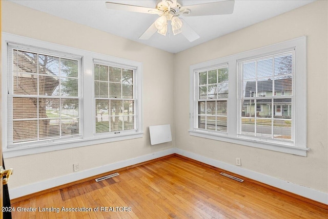 spare room with ceiling fan and hardwood / wood-style floors