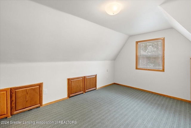 bonus room featuring carpet floors and vaulted ceiling