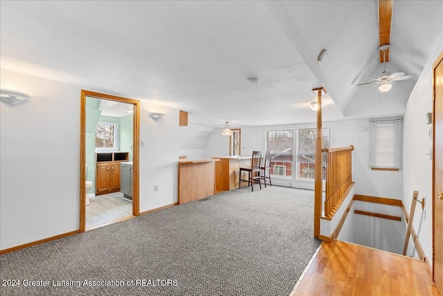 living room with light hardwood / wood-style floors, ceiling fan, and lofted ceiling