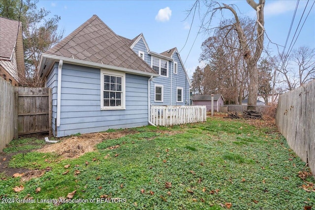 rear view of property with a lawn