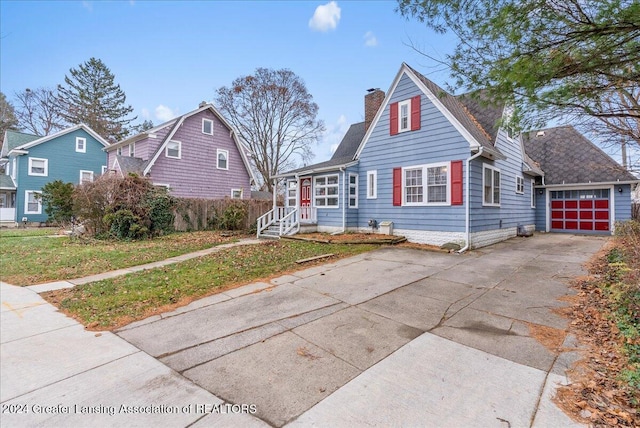 view of front facade with a front yard and a garage