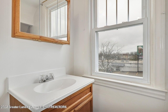 bathroom with plenty of natural light and vanity