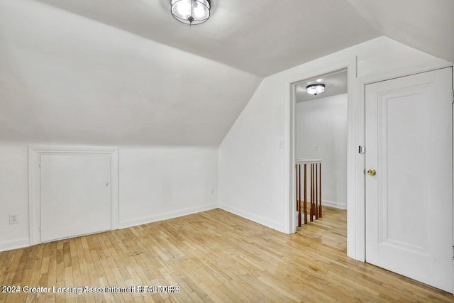 bonus room featuring light hardwood / wood-style flooring and vaulted ceiling