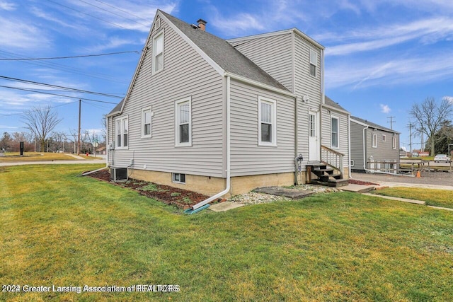 view of home's exterior featuring a yard and central air condition unit