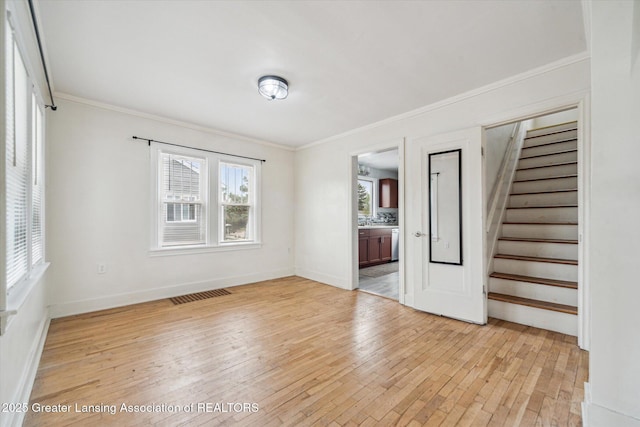 336 S Waverly Rd, Lansing, MI 48917 - spare room with light wood-style floors, crown molding, stairs, and baseboards