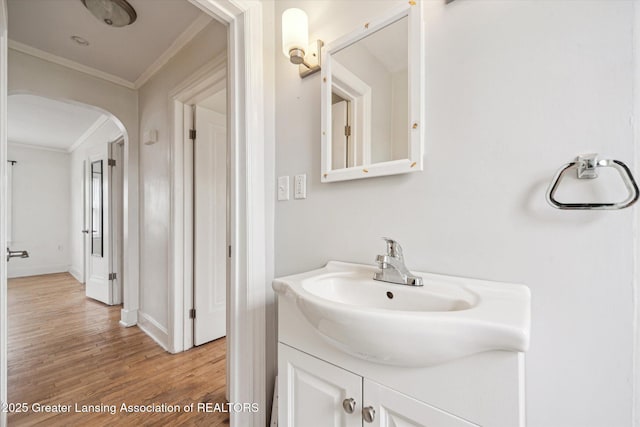 336 S Waverly Rd, Lansing, MI 48917 - bathroom with crown molding, wood finished floors, vanity, and baseboards