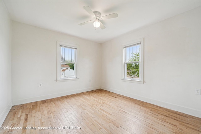336 S Waverly Rd, Lansing, MI 48917 - spare room with plenty of natural light, hardwood / wood-style flooring, ceiling fan, and baseboards