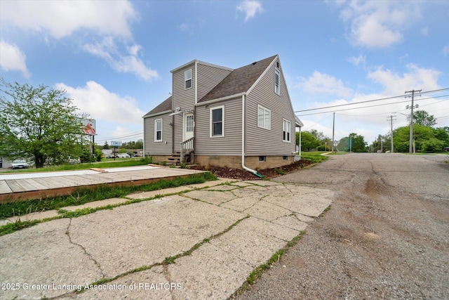 336 S Waverly Rd, Lansing, MI 48917 - view of side of home with entry steps and roof with shingles