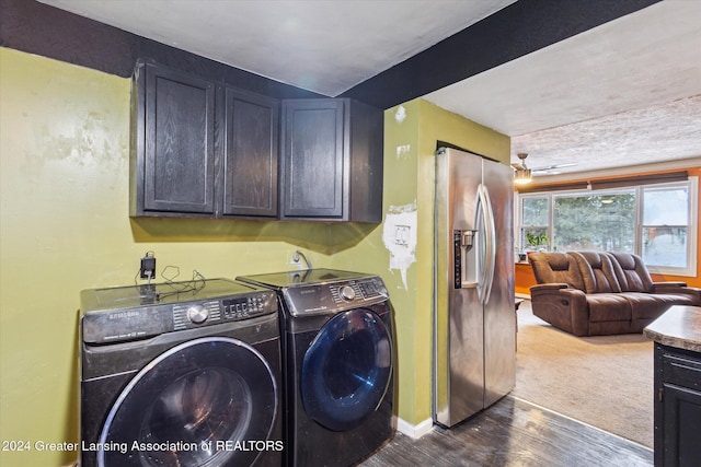 washroom with washer and dryer, cabinets, and dark hardwood / wood-style floors