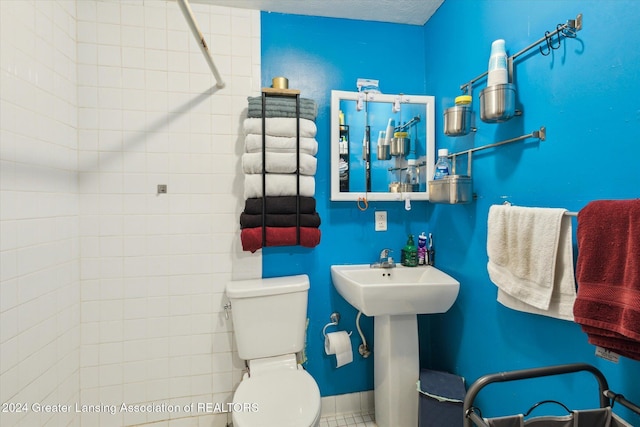 bathroom with toilet and a textured ceiling