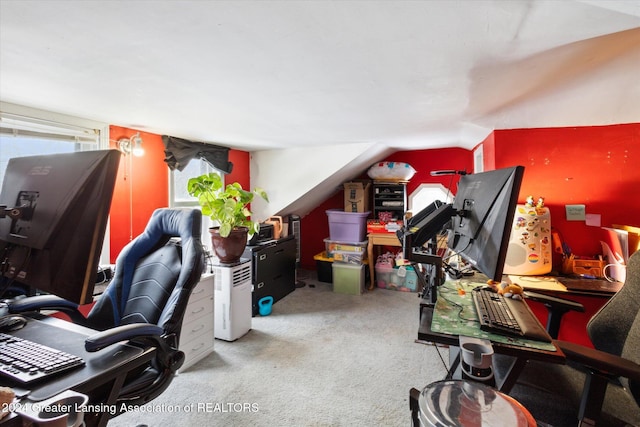 office space with light carpet and vaulted ceiling