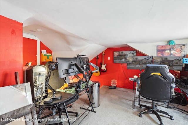 home office featuring vaulted ceiling and carpet