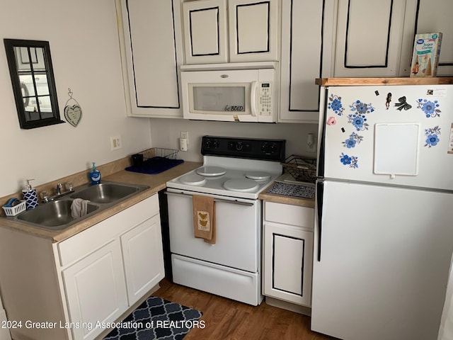 kitchen with white appliances, dark wood-type flooring, and sink