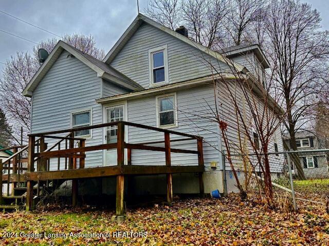 back of house featuring a wooden deck