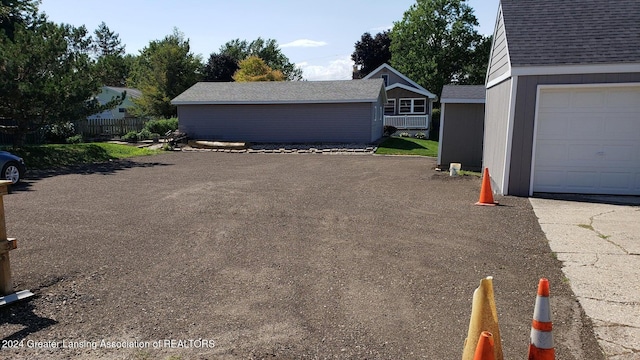 view of property exterior with a garage and an outdoor structure