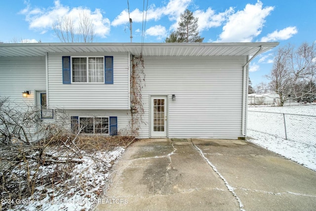 view of snow covered rear of property