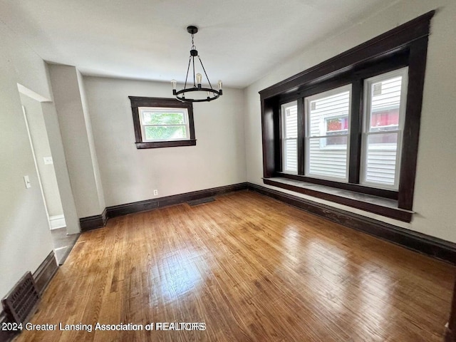 unfurnished dining area featuring hardwood / wood-style flooring