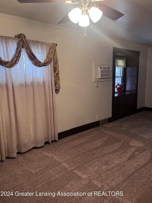 spare room featuring ceiling fan, carpet floors, ornamental molding, and a wall unit AC