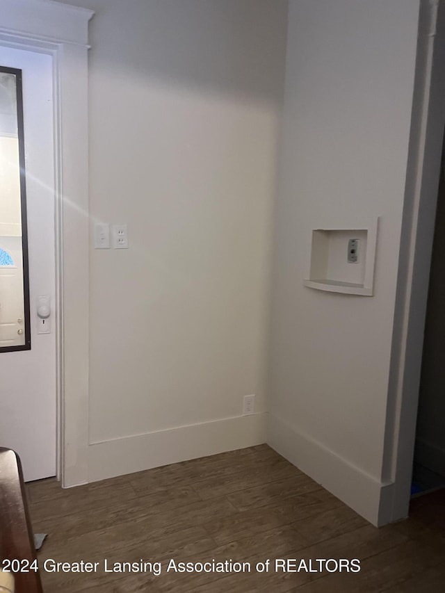 laundry area with dark hardwood / wood-style flooring