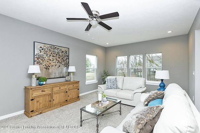 living room with light carpet, ceiling fan, and a healthy amount of sunlight