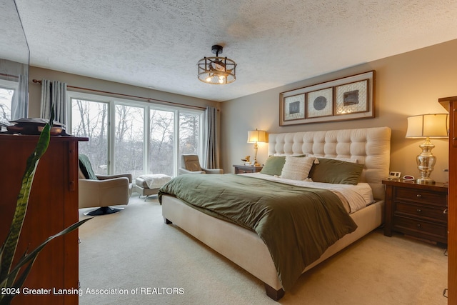 carpeted bedroom featuring a textured ceiling