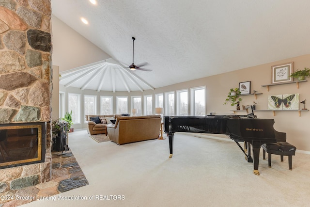 living room featuring lofted ceiling, a fireplace, and a wealth of natural light