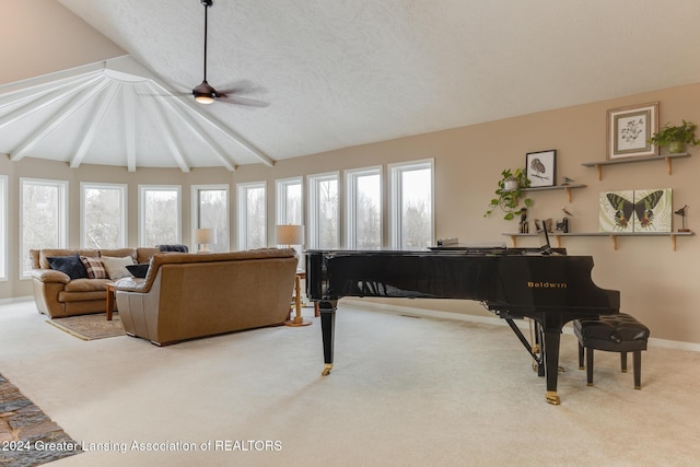 carpeted living room with a textured ceiling, lofted ceiling with beams, a wealth of natural light, and ceiling fan