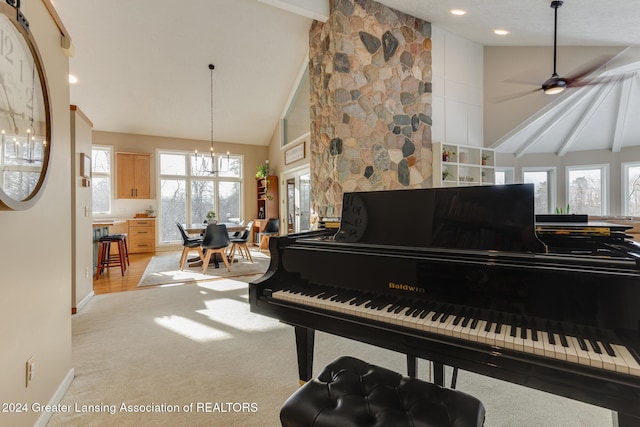 misc room featuring beamed ceiling, ceiling fan with notable chandelier, light carpet, and high vaulted ceiling