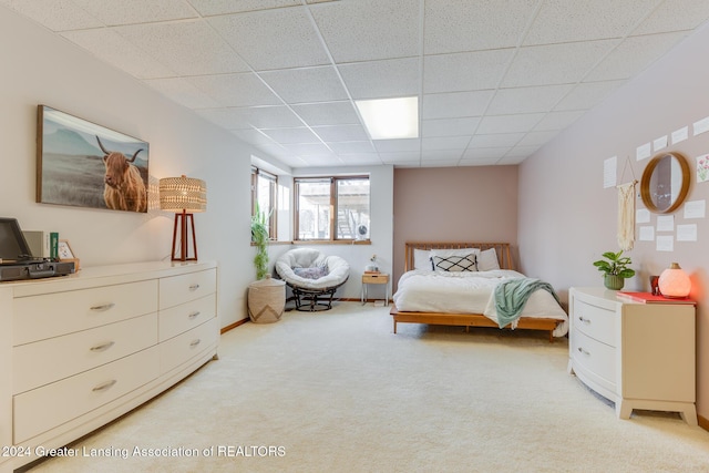 carpeted bedroom with a drop ceiling