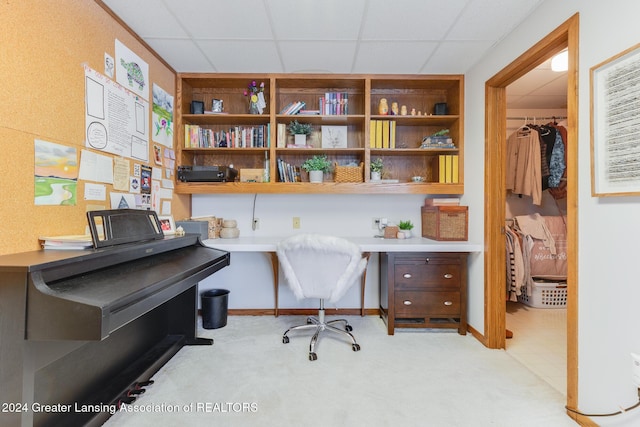 office area with a paneled ceiling