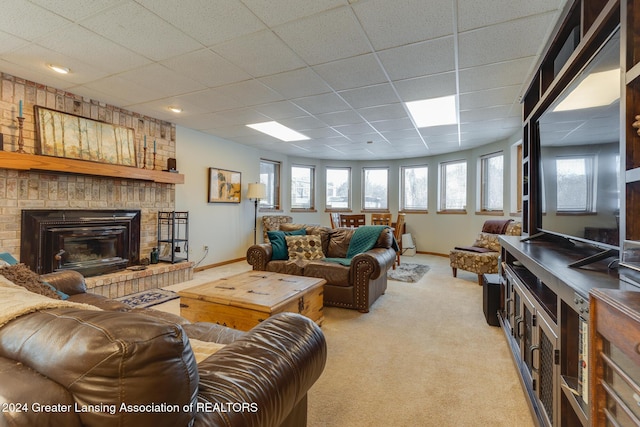 carpeted living room featuring a paneled ceiling, a wealth of natural light, and a brick fireplace