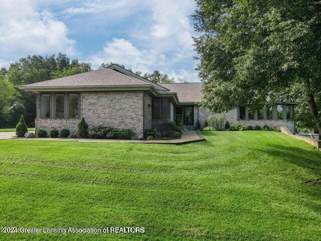 view of side of home with a lawn