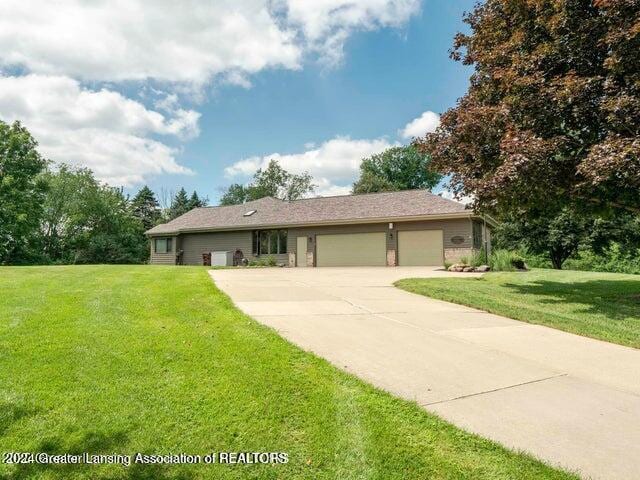 ranch-style home with a front yard and a garage