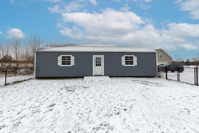 view of snow covered rear of property