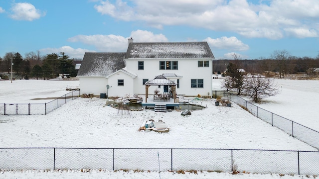 snow covered property with a gazebo and a wooden deck