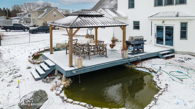 snow covered deck with a gazebo and grilling area